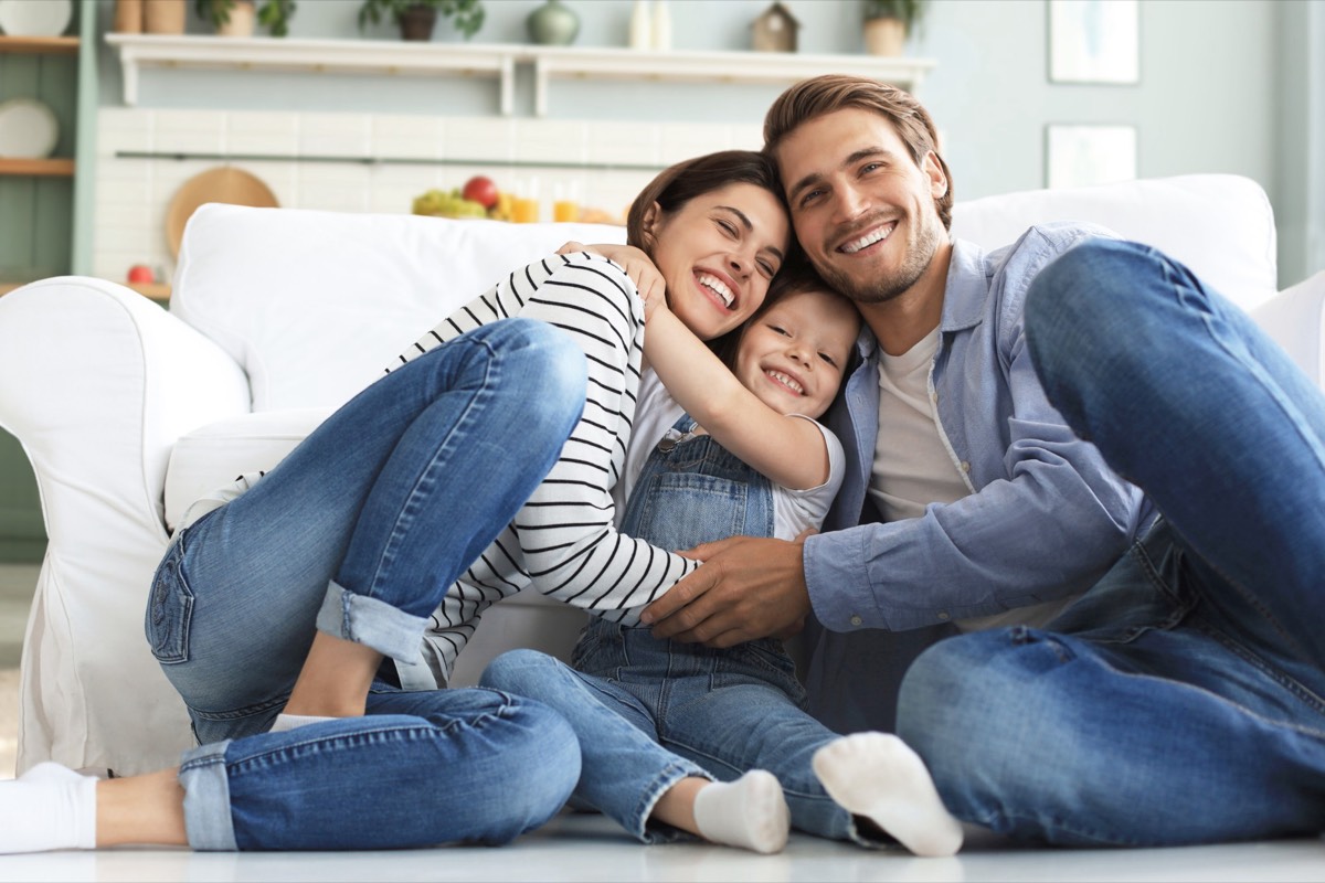 Smiling family with a young child at home, Curodont treatment for early cavities in Shelby Township, MI